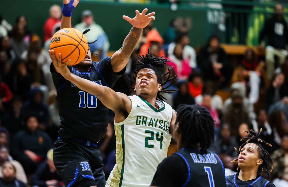 Grayson senior guard Gicarri Harris splits two defenders on his way to the basket. (Photo: Colin Hubbard)